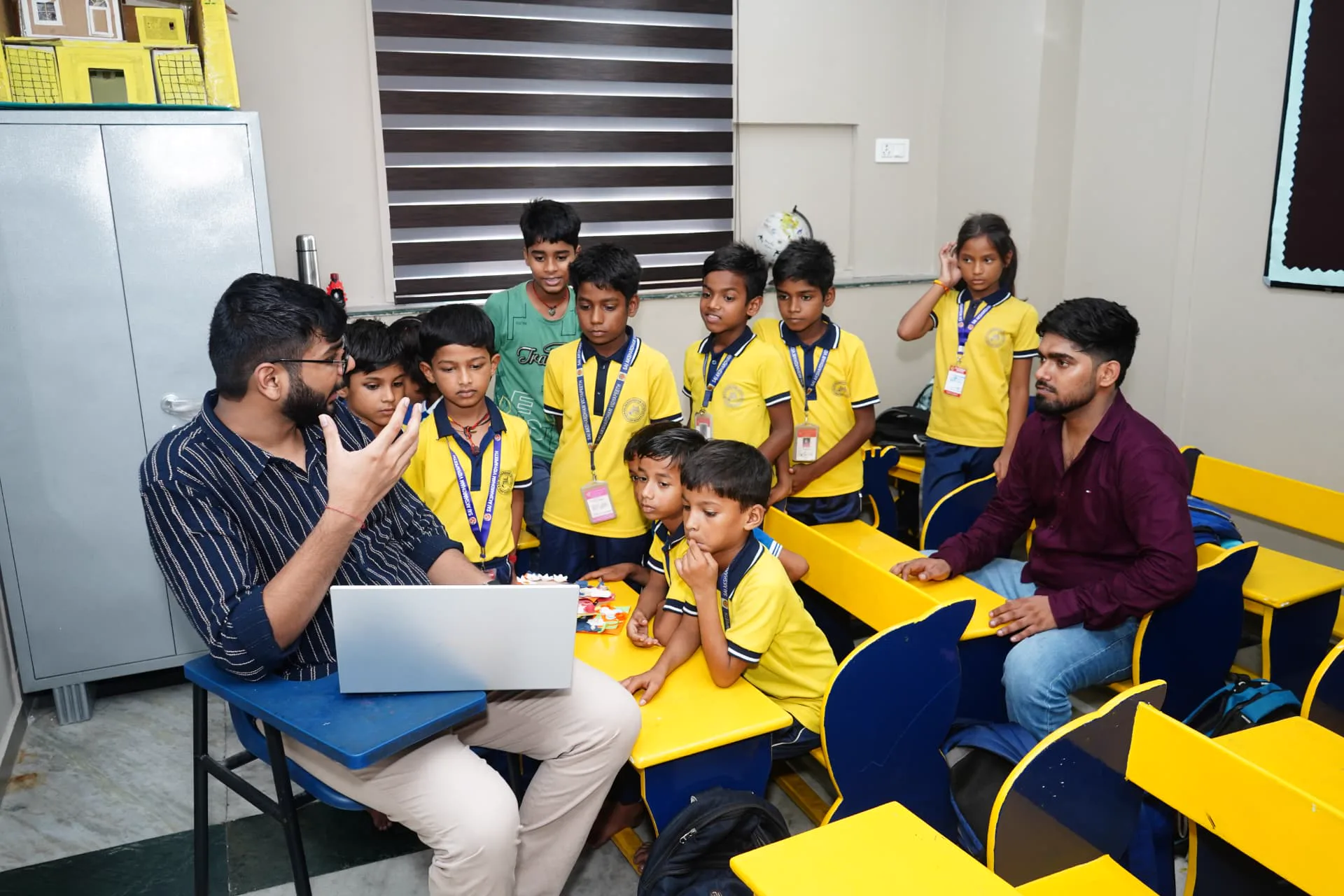 Students gathered around a mentor and a laptop